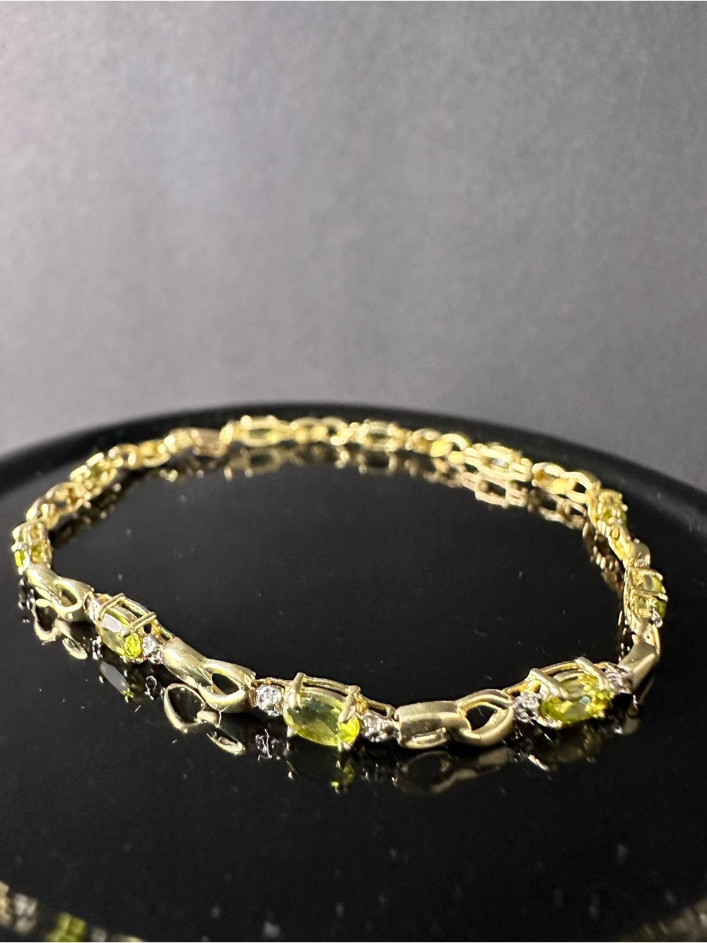 Elegant 10k yellow gold oval peridot and diamond accent link bracelet